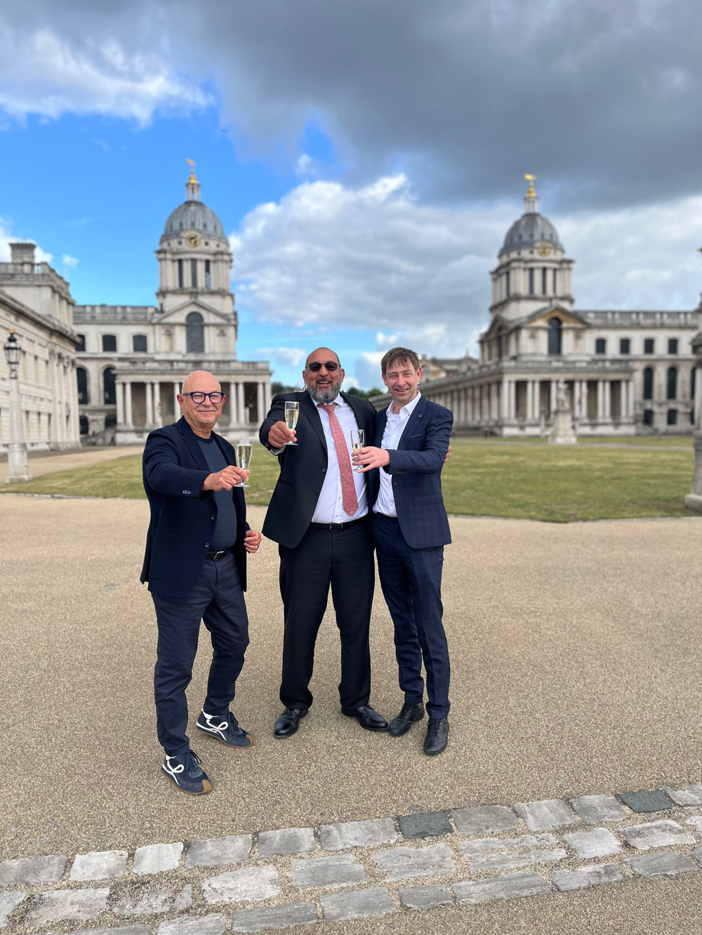 Raising a toast in front of the Old Royal Naval College, Greenwich